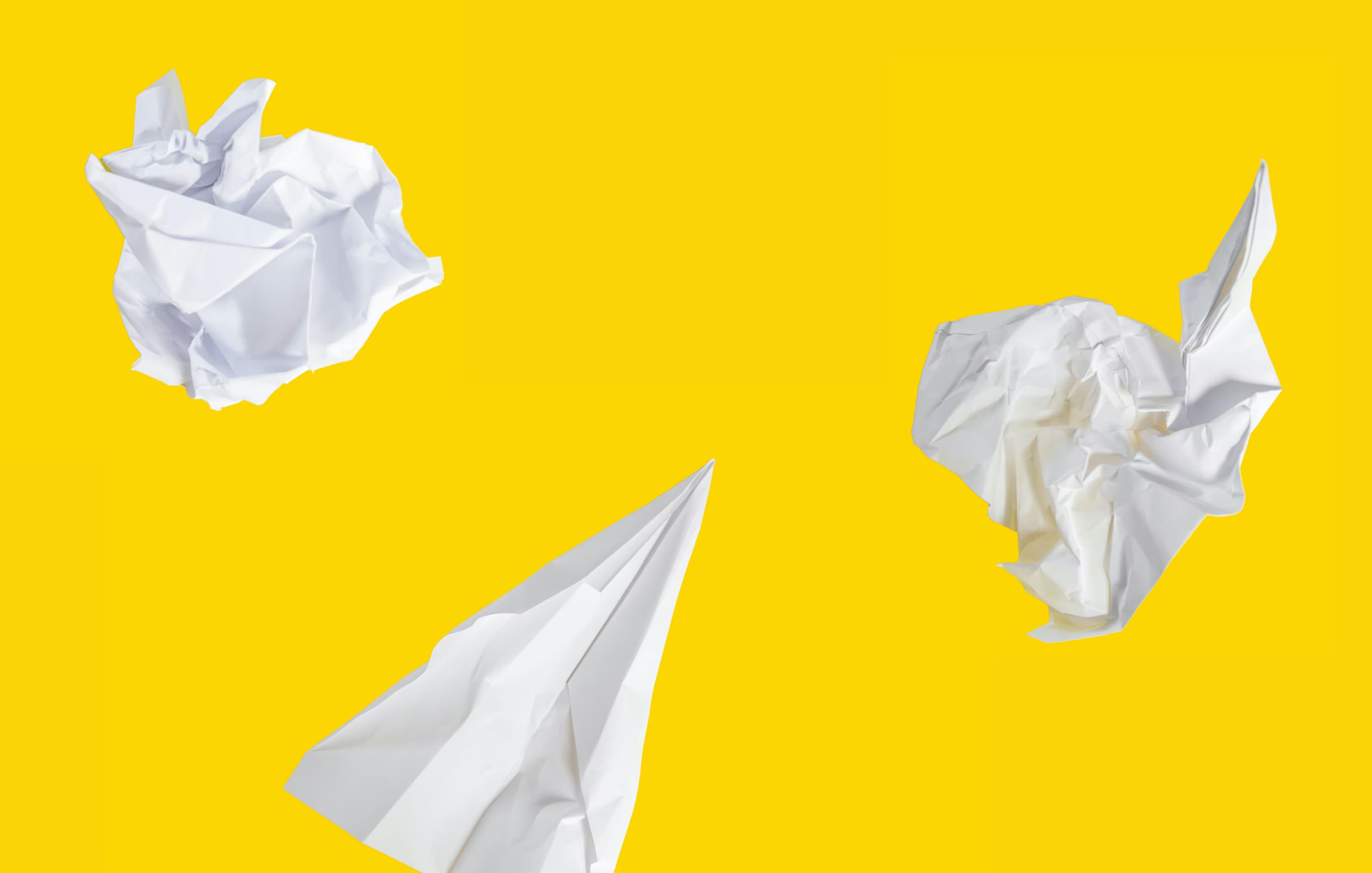 white paper airplane on yellow background
